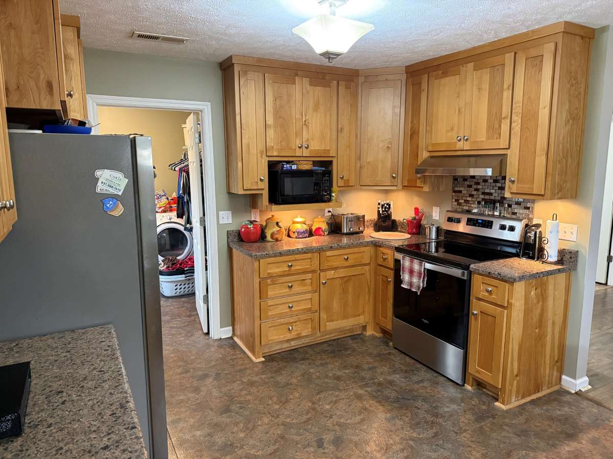 Kitchen- laminate flooring, wood cabinetry