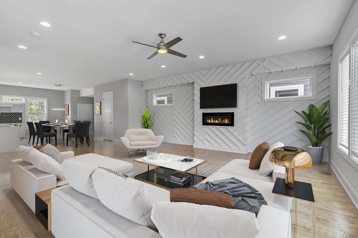 Fireplace set into designer accent wall. Virtually staged, viewing into a shared dining room space