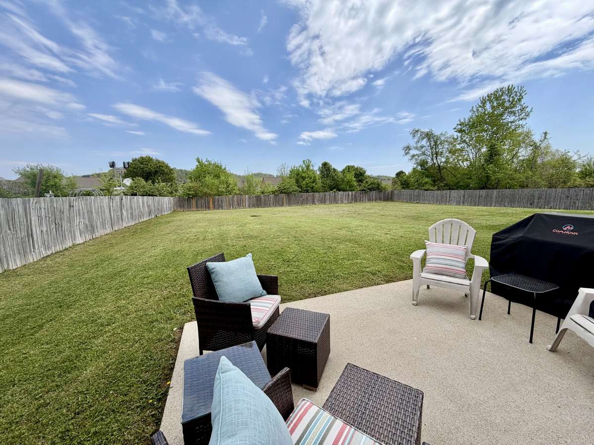 Enjoy a spacious backyard with partial fencing and room to make it your own.