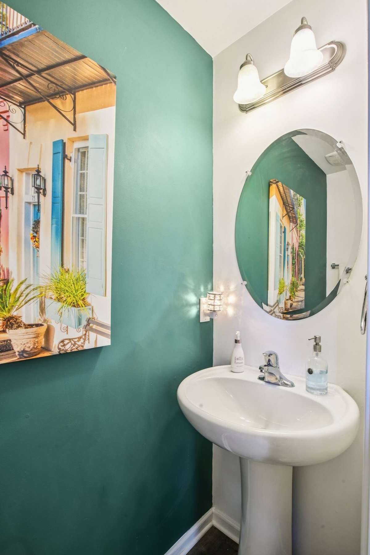 Half bath on the main level located near the entry and staircase, providing convenient access for guests and daily use.