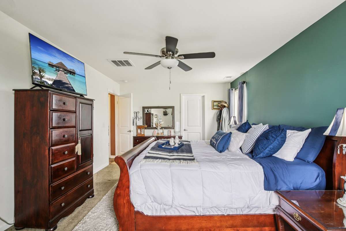 Spacious primary suite filled with natural light, featuring a walk-in closet and private ensuite bath.