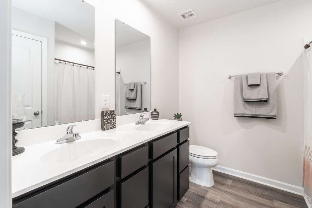 Primary bathroom with dual sinks and convenient tub/shower combo