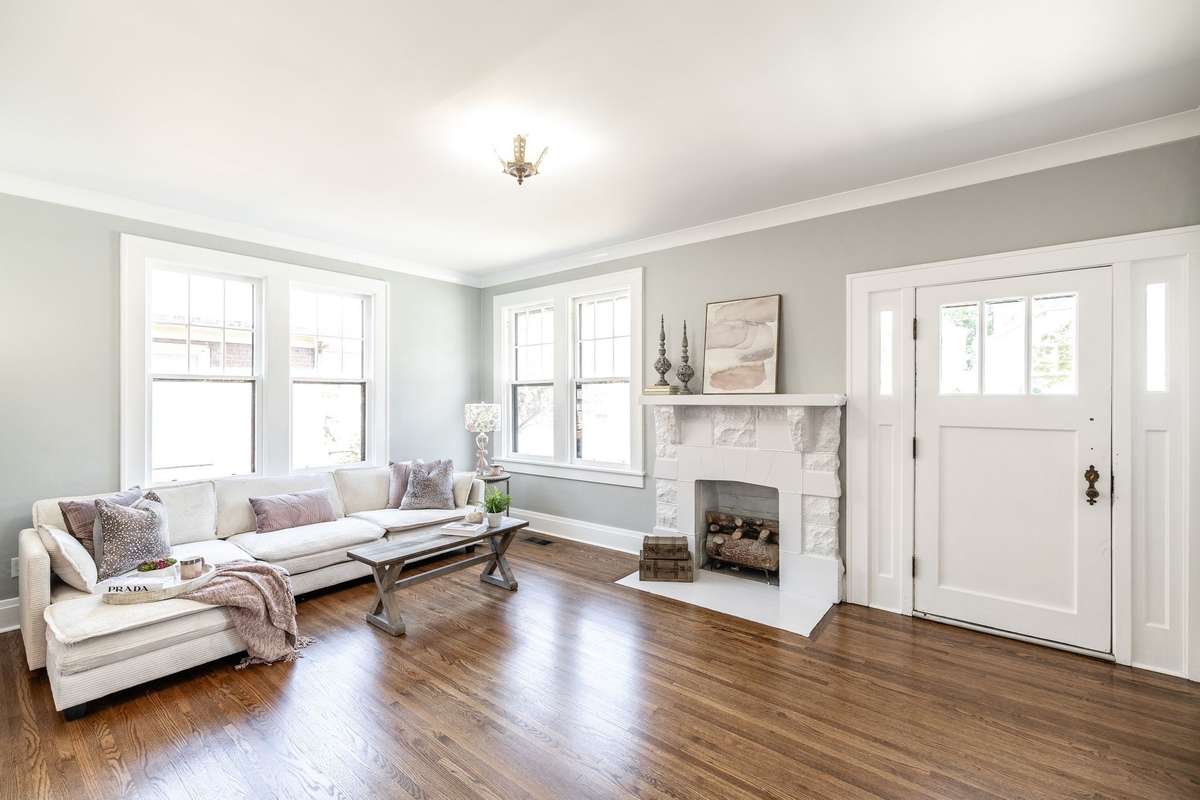 Let's go inside and take a look around! Spacious main living area with gleaming hardwood floors and abundant natural light creating a warm and inviting space.