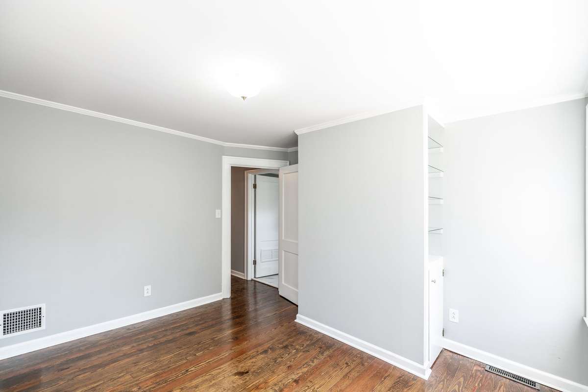 This room might make a great home office or hobby room with the built in cabinet and shelves!