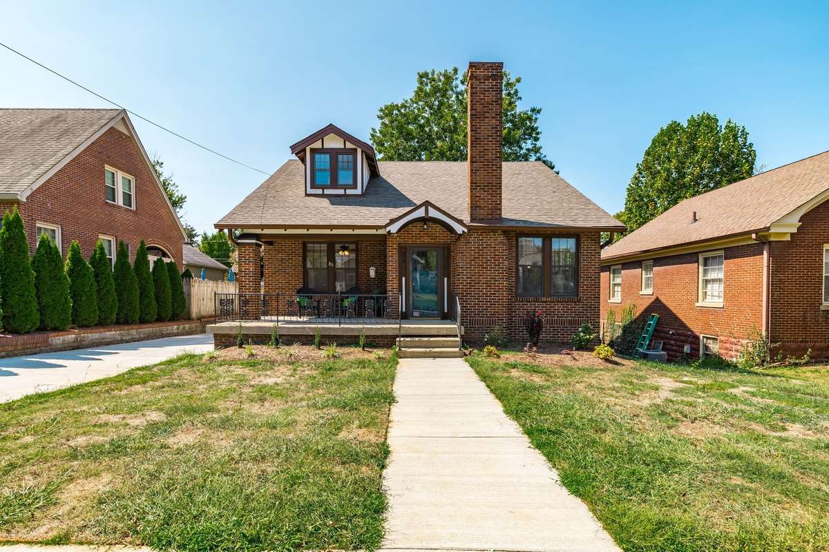 A charming all-brick exterior with a classic rocking chair front porch that sets the perfect welcoming for guests!