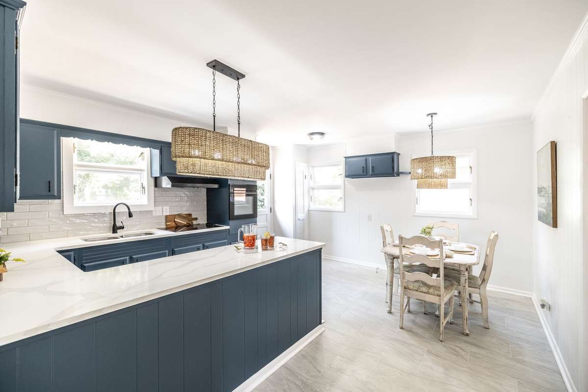 Bright and cheerful kitchen with painted cabinets and quartz countertops, offering a clean and timeless look