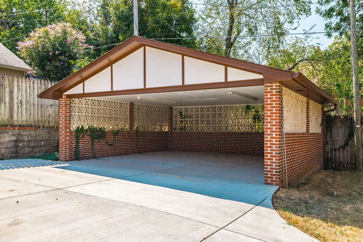 Sturdy detached brick carport with timeless design, complementing the home’s historic character.