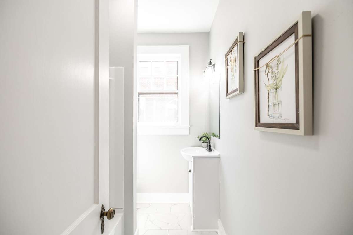 Tile flooring and neutral finishes give this bathroom a timeless look that complements the home’s character.