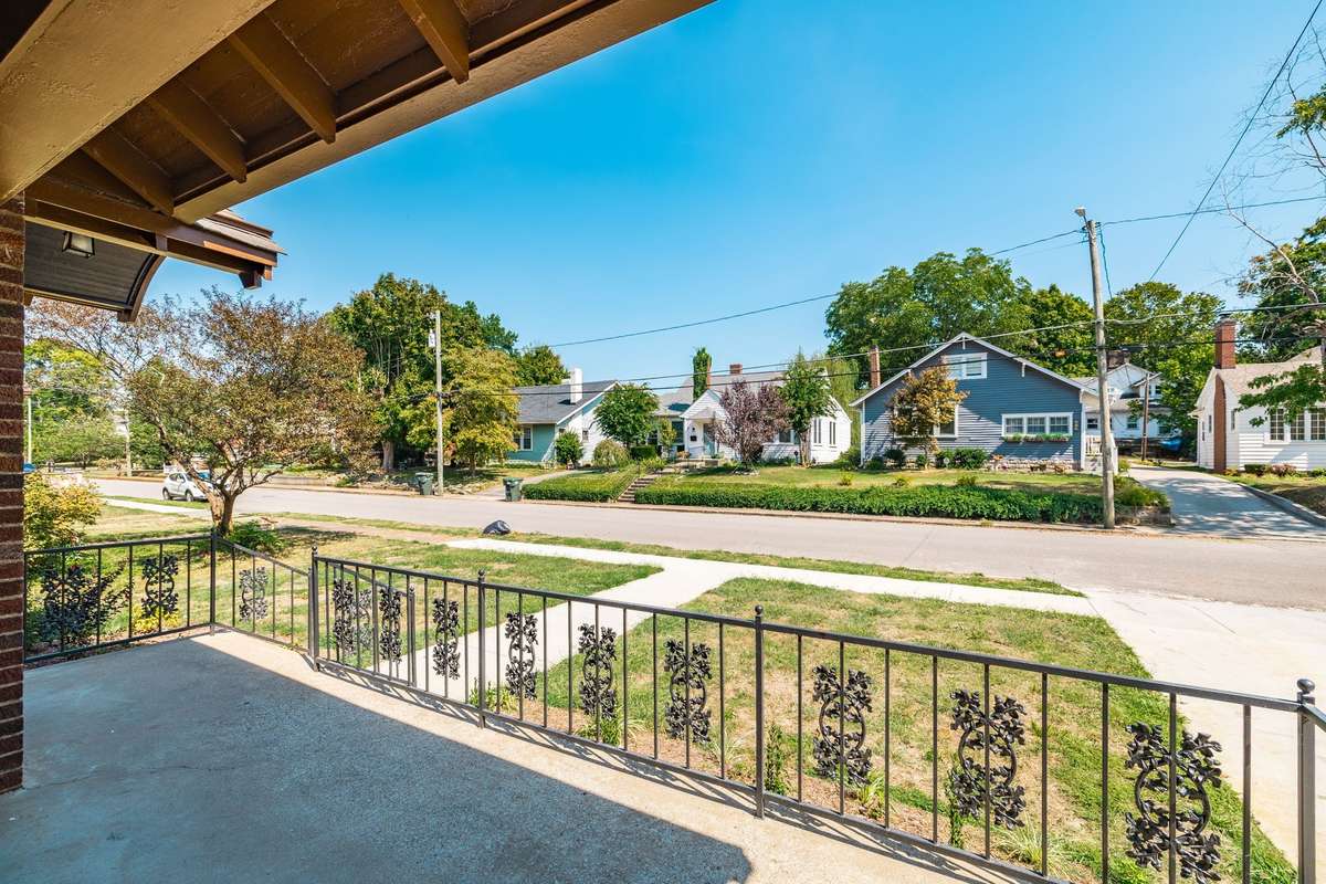 A street-view perspective showing the home’s setting in the heart of the historic district with mature trees and a pedestrian-friendly atmosphere.