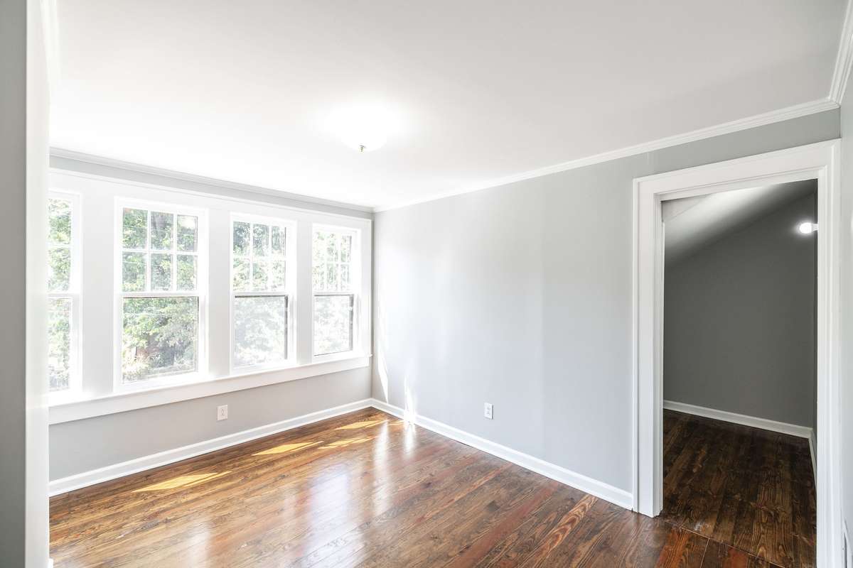 Second upstairs bedroom offers a cozy retreat with plenty of room for furniture and storage