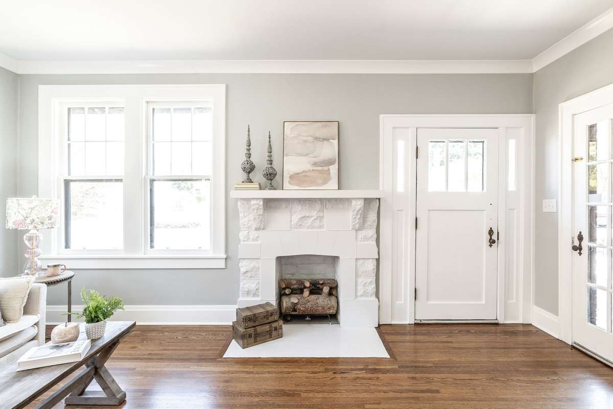 The original fireplace serves as a beautiful focal point, adding timeless character to this thoughtfully updated home.