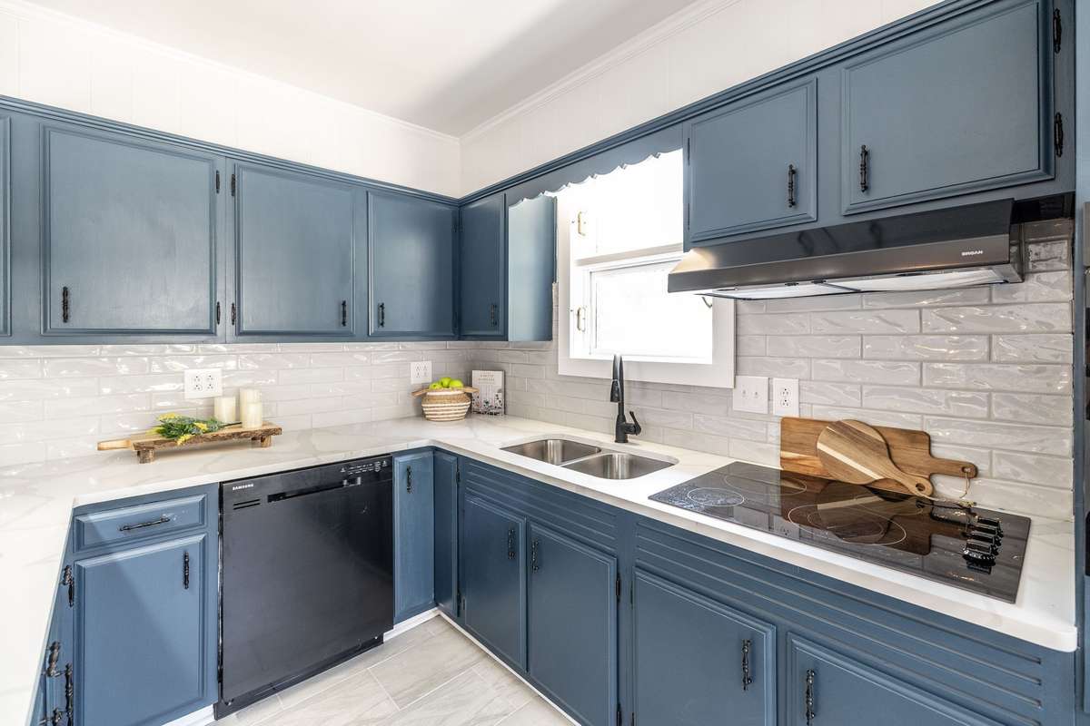 A closer look at the painted cabinets and hardware, showing the careful balance of modern style and historic character