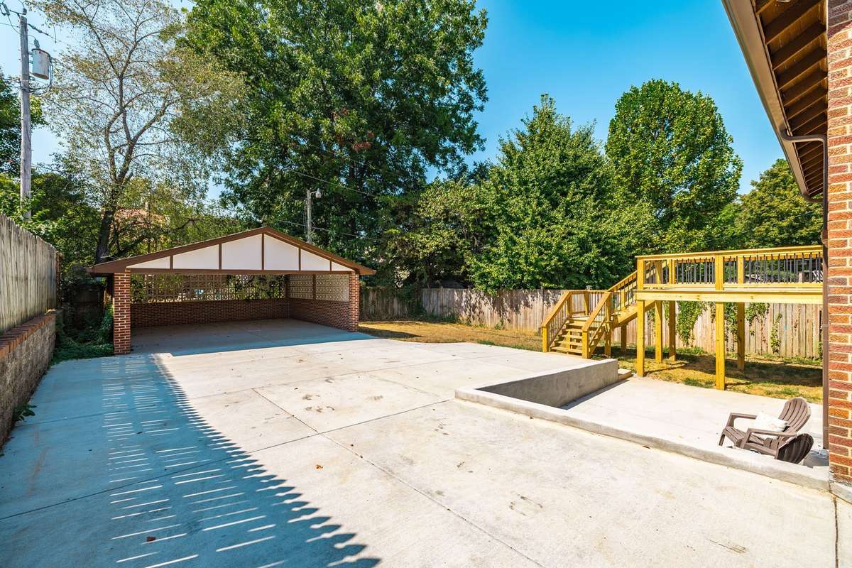 A covered two-car carport offers ample parking and protection from the elements