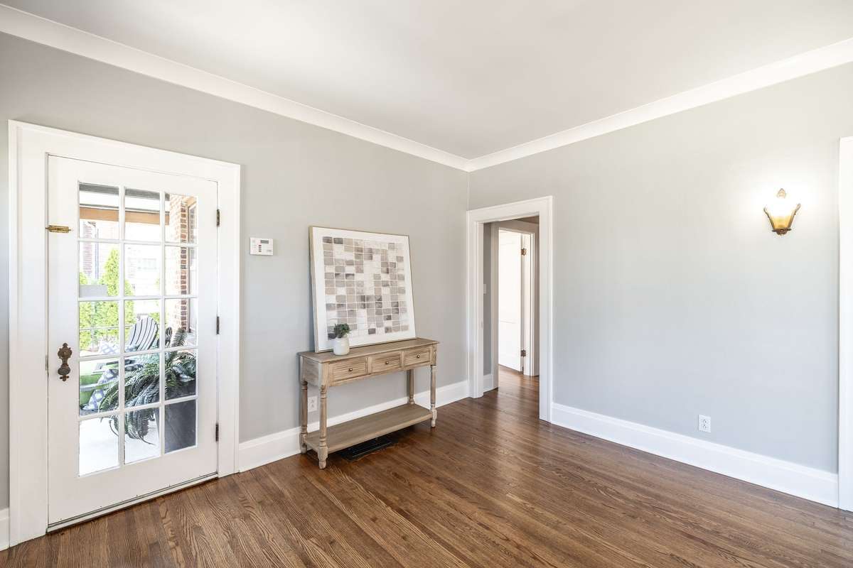 Neutral paint tones and preserved architectural details make this space easy to style while celebrating its original charm.