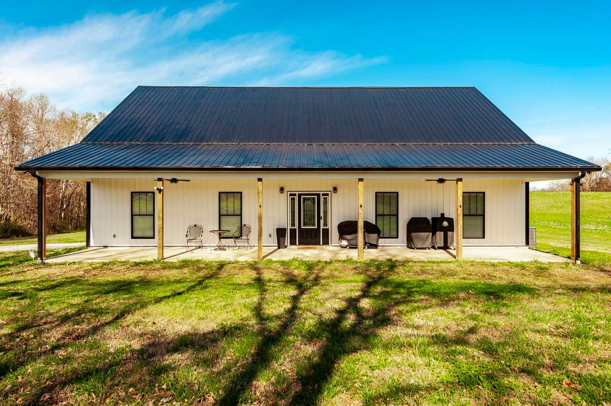 With plenty of room to gather, the covered front porch creates a welcoming space to enjoy quiet mornings and evening sunsets.