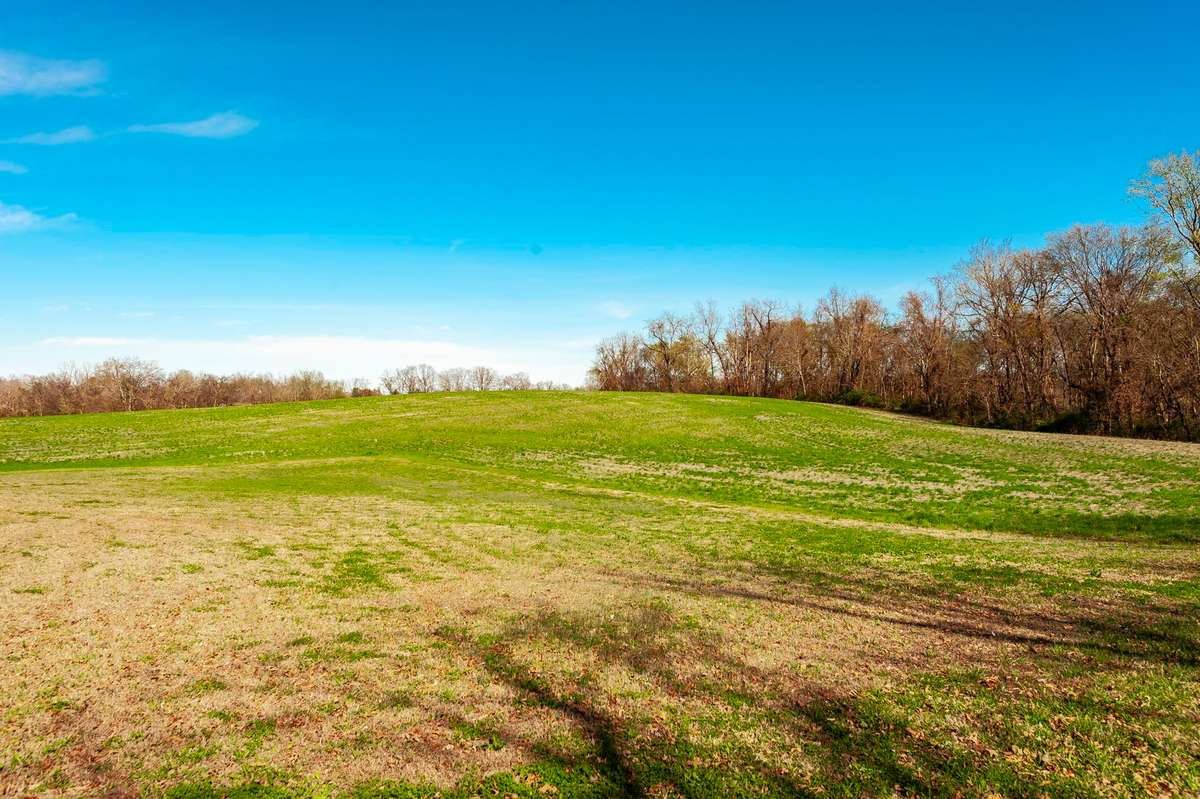 From the large covered back porch, take in sweeping views of open farmland, serene skies, and the quiet beauty of this private 1.35-acre setting — the perfect backdrop for relaxing and enjoying country living.