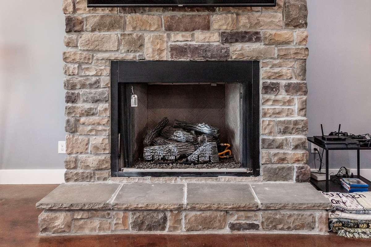Whether enjoying a quiet evening or hosting guests, the fireplace creates a relaxing atmosphere in the heart of the home.