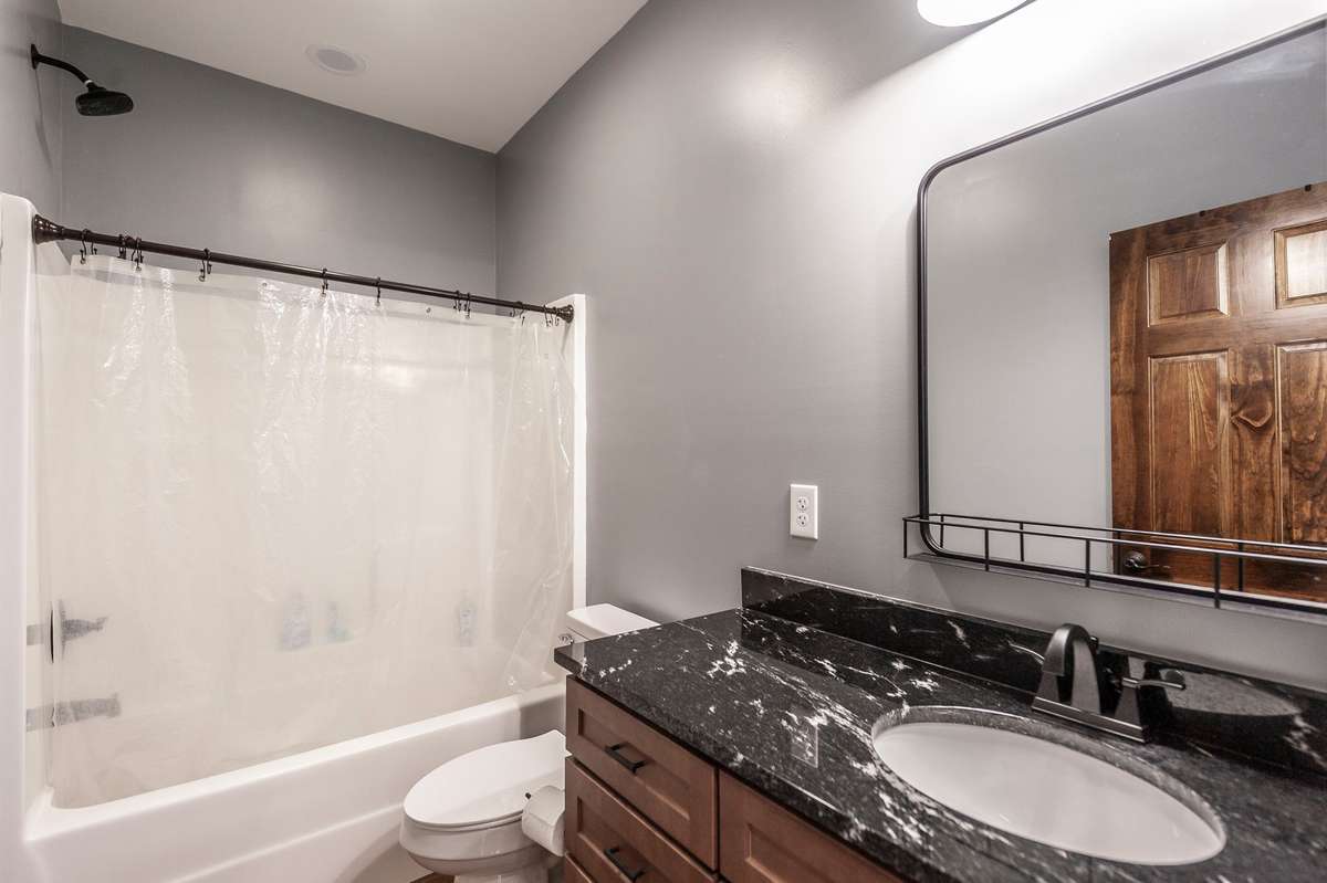 The guest bath is easily accessible to both guest rooms and has all the beautiful features of stain and granite.