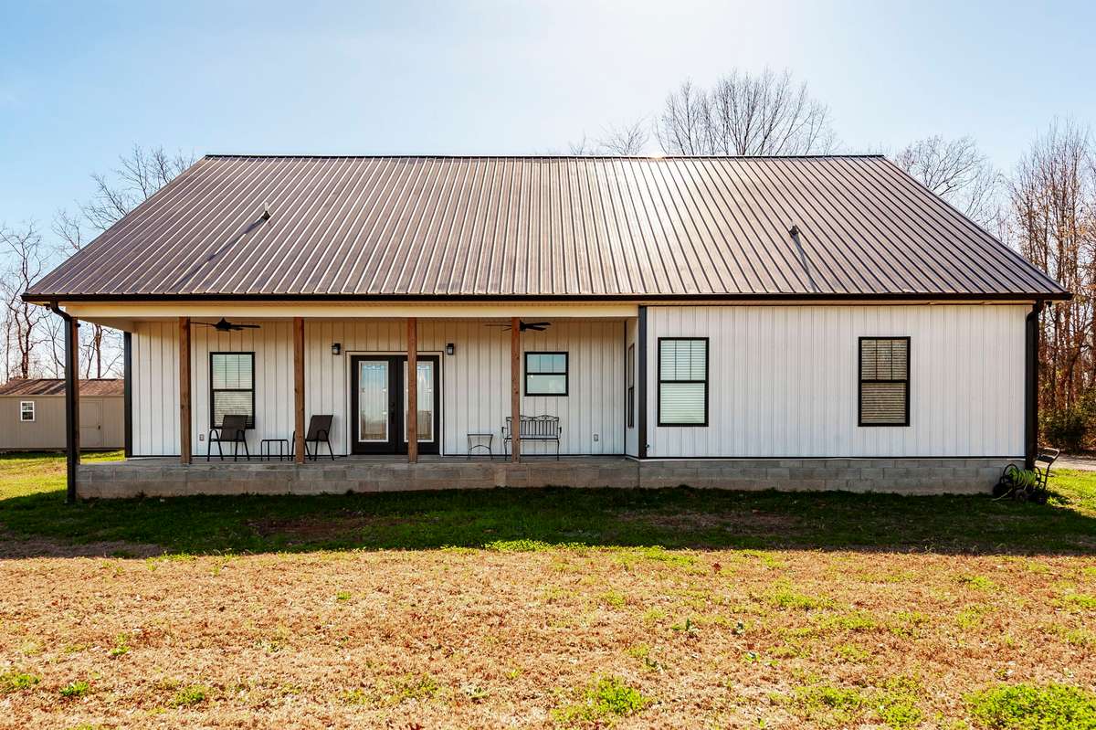 The covered back porch offers a great extension of the home, ideal for outdoor dining, entertaining, or quiet evenings outside.