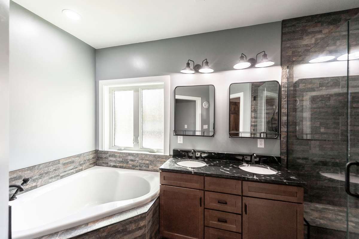 The combination of tile flooring and elegant fixtures gives the space a polished, timeless look.