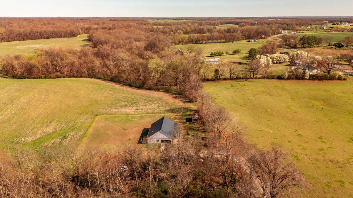 Country Living at Its Best – From this elevated perspective, the property’s beautiful rural setting becomes clear, with wide-open farmland surrounding the home and providing a peaceful, scenic environment.