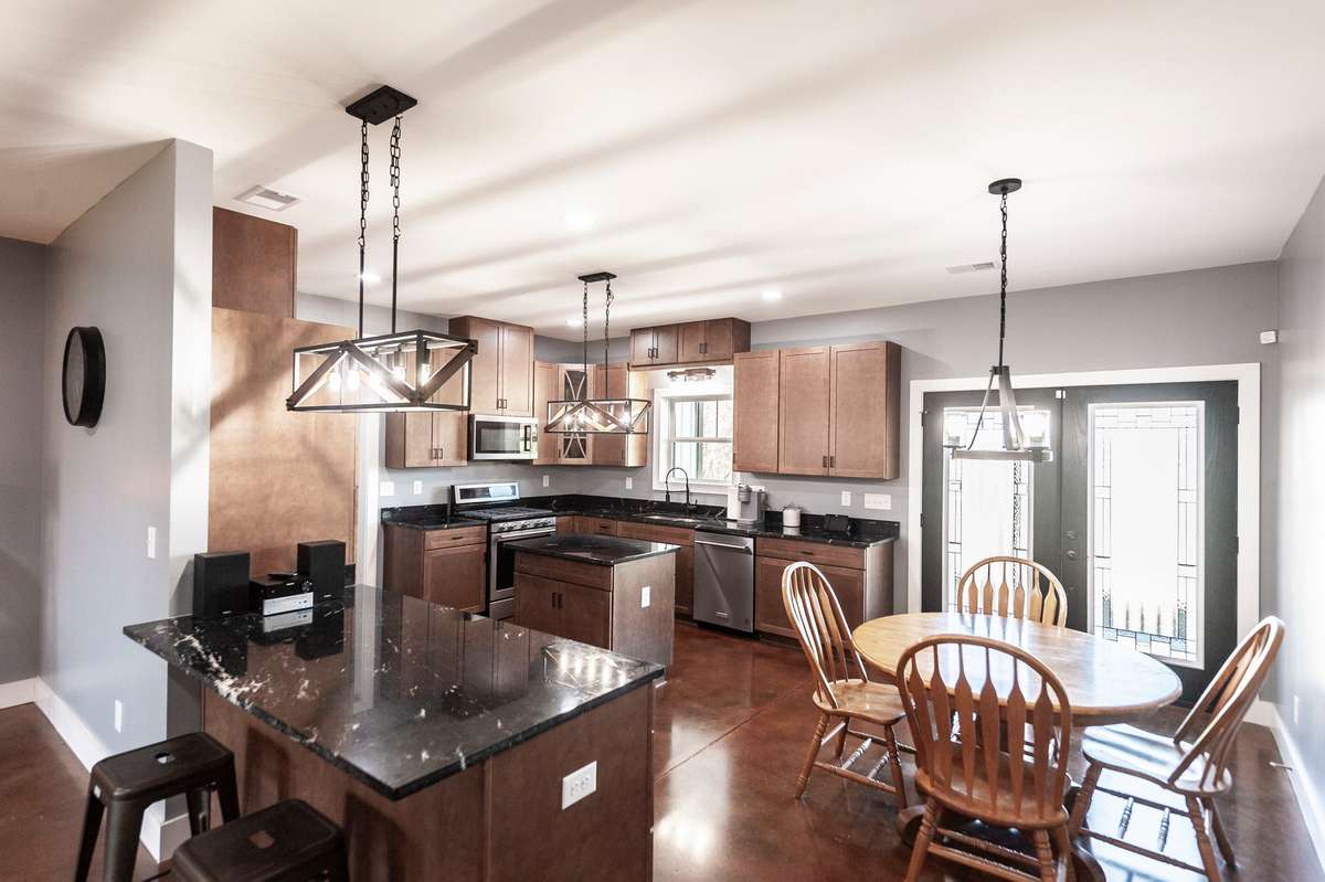 This spacious living room flows seamlessly into the kitchen and dining area, making it perfect for both everyday living and entertaining.