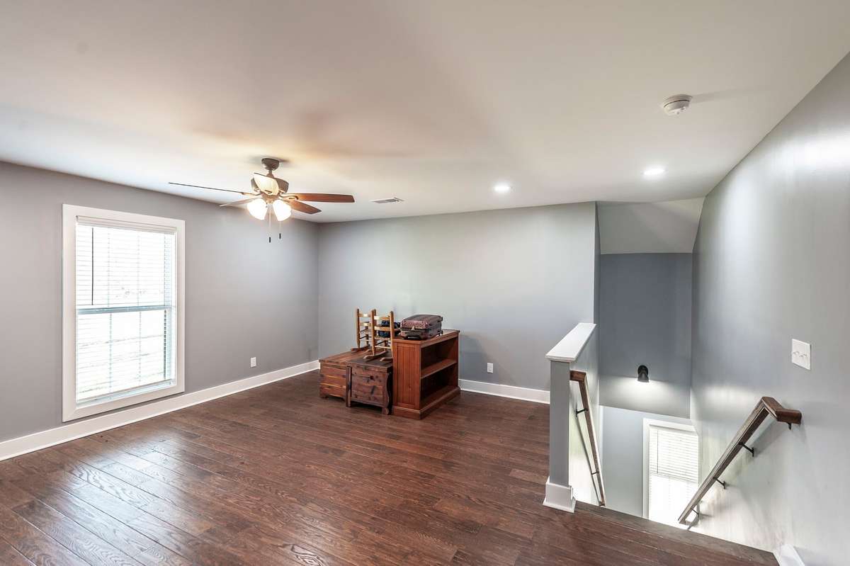 The upstairs bonus room is a spacious, open area with beautiful hardwood floors and endless possibilities.