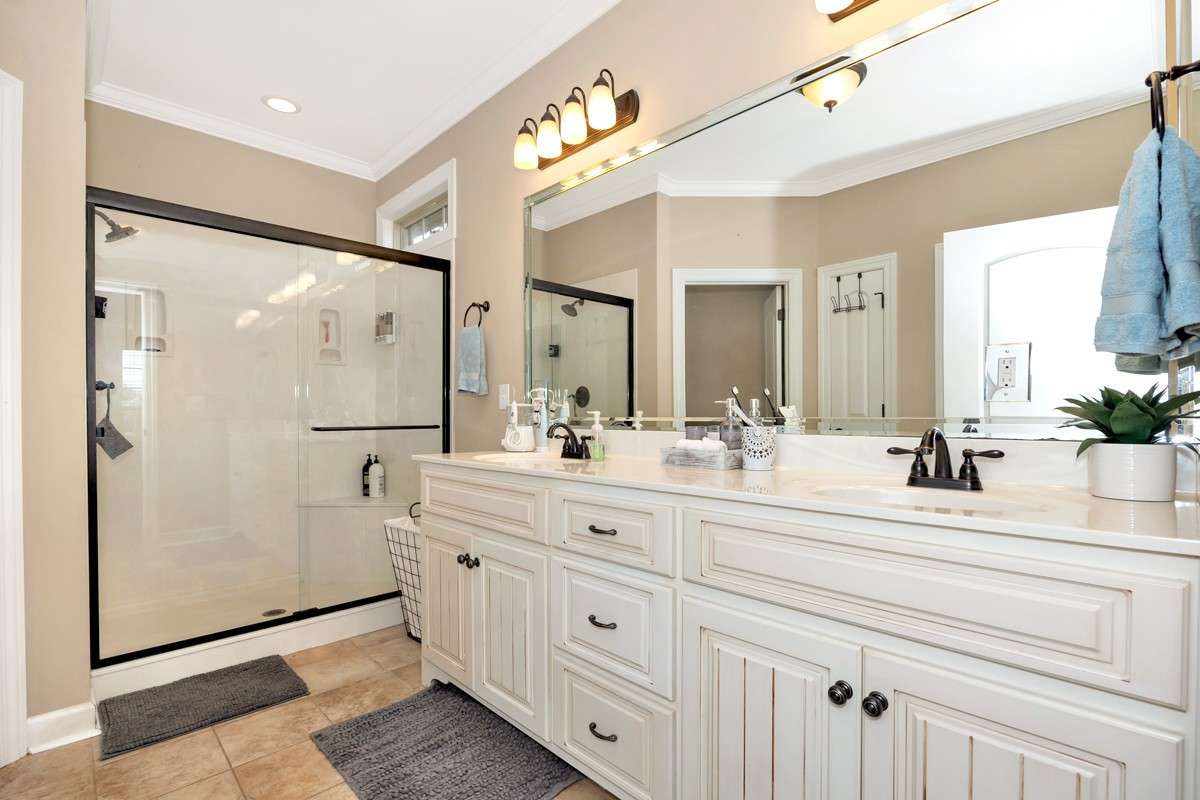 Glamour Bath- Tile flooring, crown molding, recessed lighting, double vanities, walk-in closet