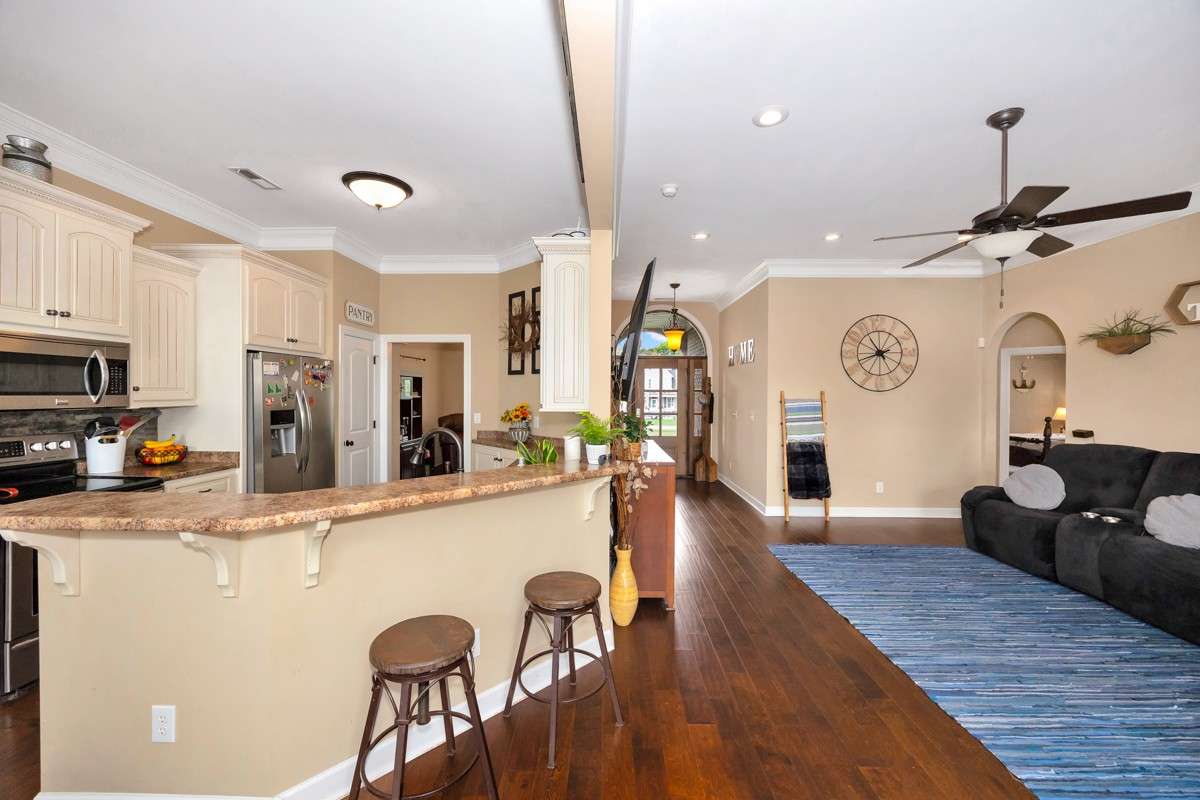 Living Room- Wood flooring, crown molding, ceiling fan, recessed lighting, 10'ceiling