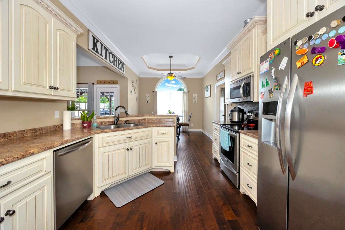 Kitchen- Wood flooring, pantry, crown molding, eat-in kitchen, 10' ceiling, dishwasher, microwave, refrigerator