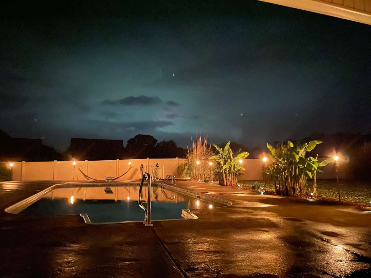 Nighttime pool- shows off the beautiful lighting and landscaping surrounding the pool