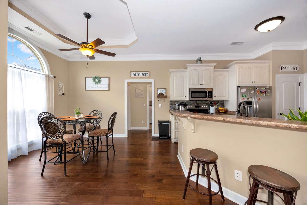 Breakfast room- Wood flooring, crown molding, trey ceiling, ceiling fan, 10' ceiling