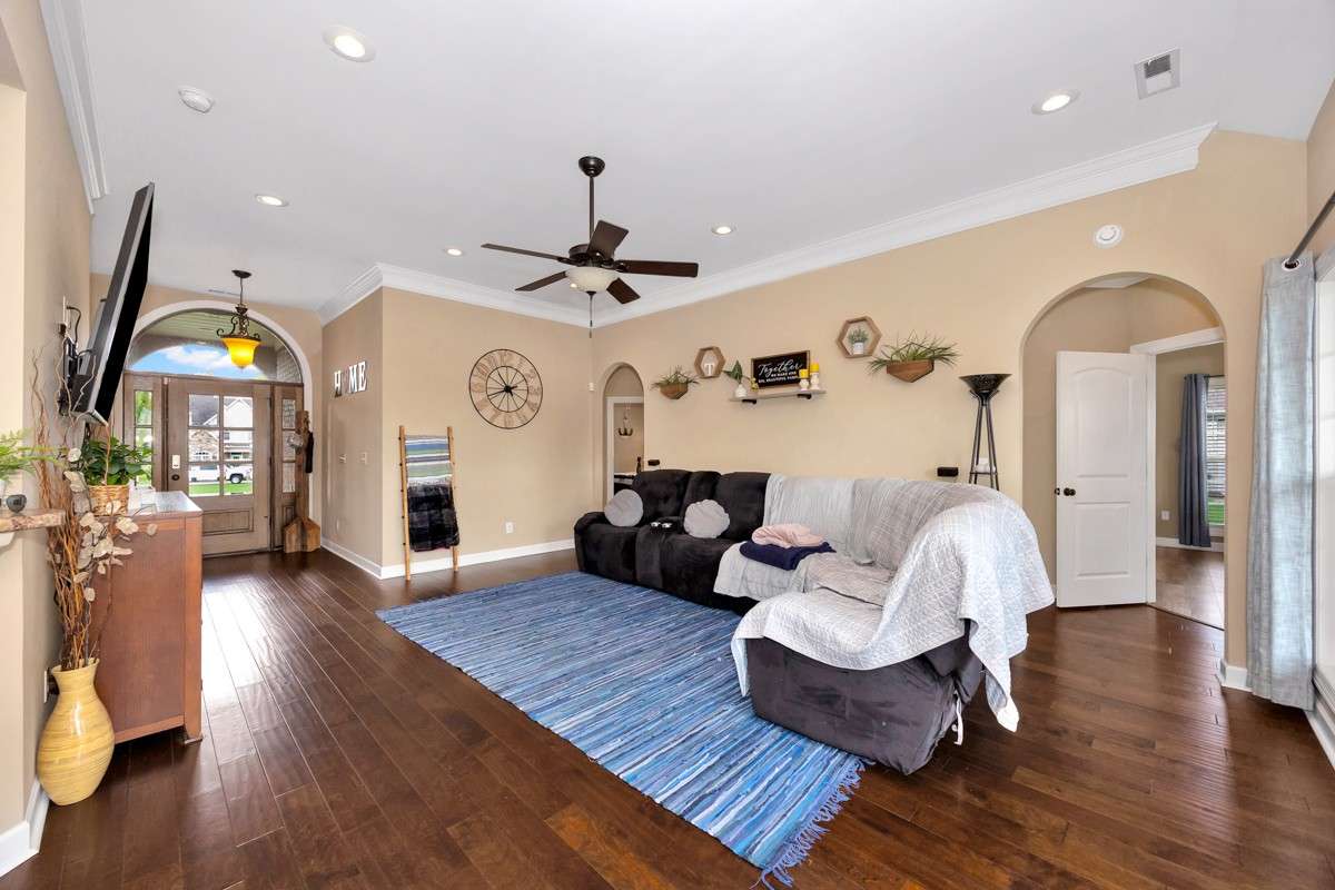 Living Room- Wood flooring, crown molding, ceiling fan, recessed lighting, 10'ceiling