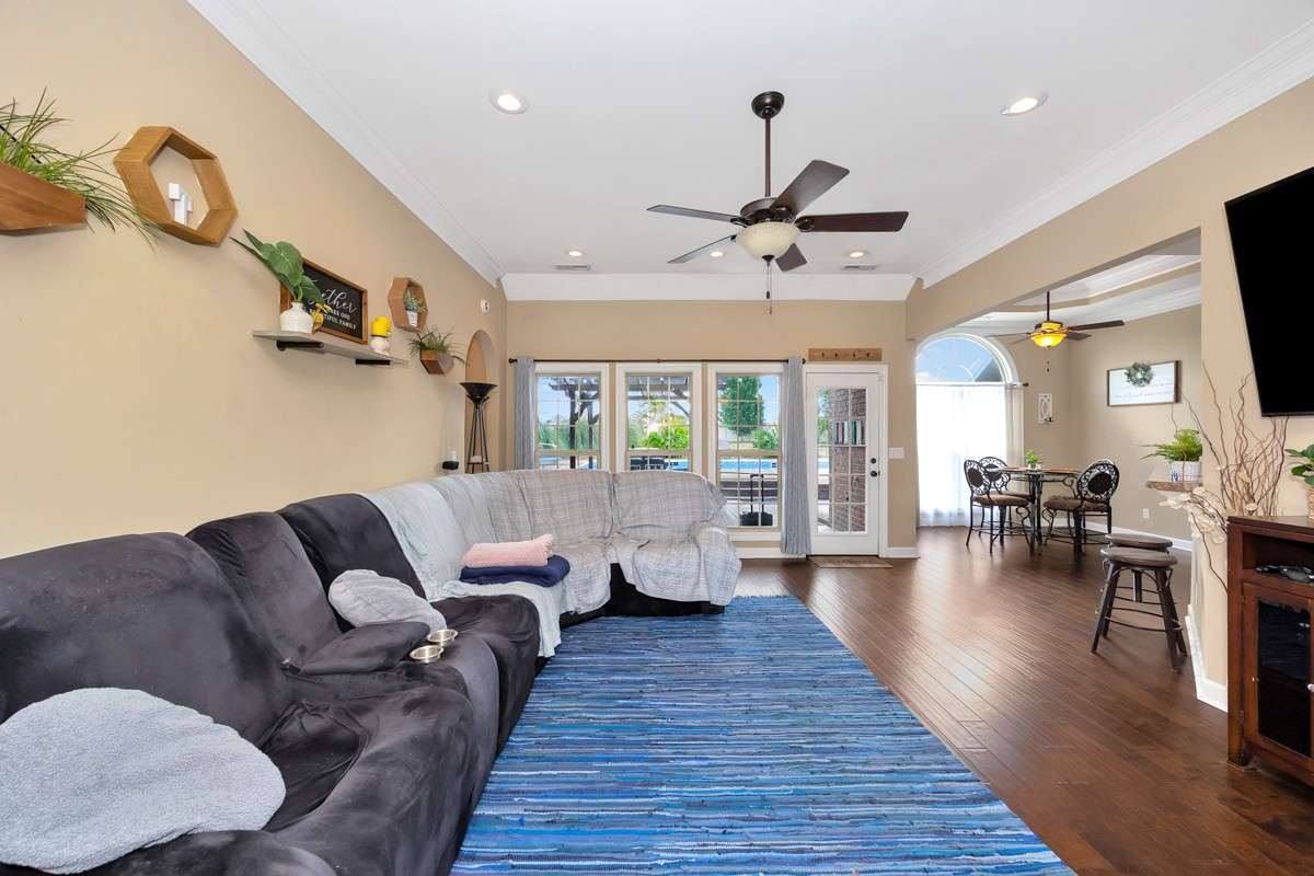 Living Room- Wood flooring, crown molding, ceiling fan, recessed lighting, 10'ceiling
