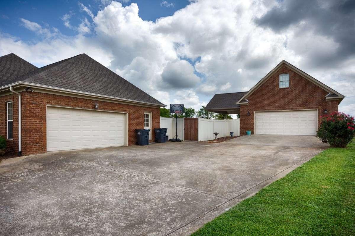 Side of house - Concrete driveway, two car attached garage, two-car detached garage