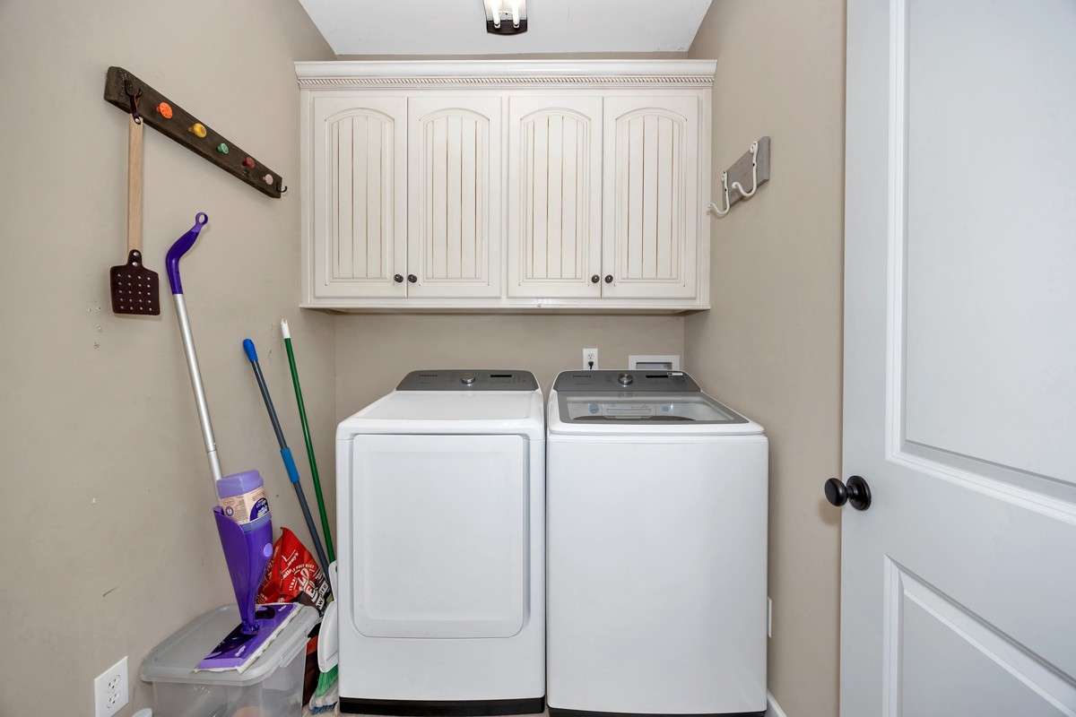 Laundry Room- Tile flooring, wood cabinetry, washer/dryer hookups