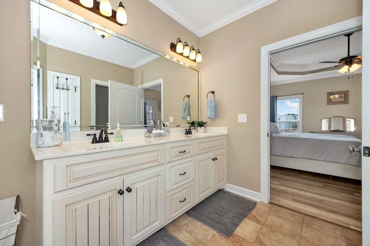Glamour Bath- Tile flooring, crown molding, recessed lighting, double vanities, walk-in closet