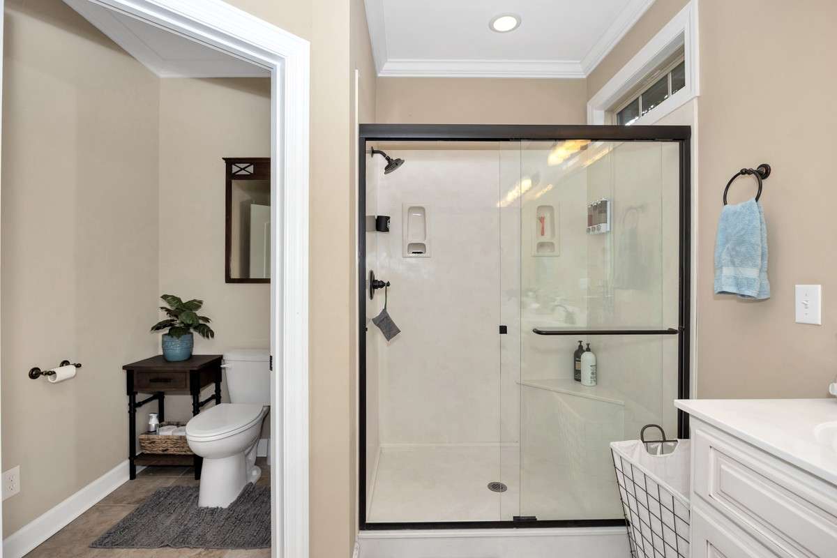 Glamour Bath- Tile flooring, crown molding, recessed lighting, double vanities, walk-in closet