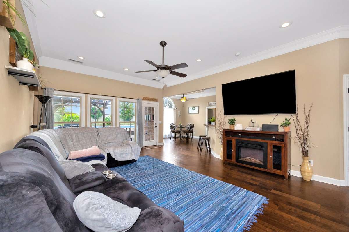 Living Room- Wood flooring, crown molding, ceiling fan, recessed lighting, 10'ceiling