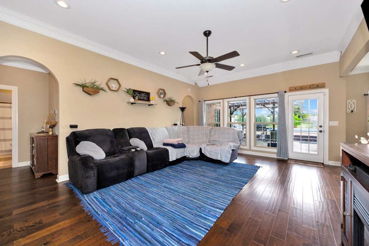 Living Room- Wood flooring, crown molding, ceiling fan, recessed lighting, 10'ceiling