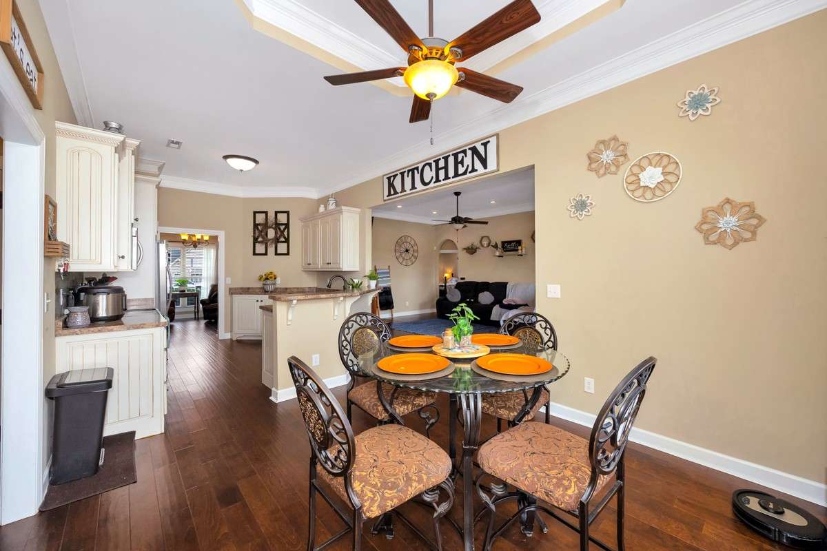 Breakfast Room- Wood flooring, crown molding, trey ceiling, ceiling fan, 10' ceiling