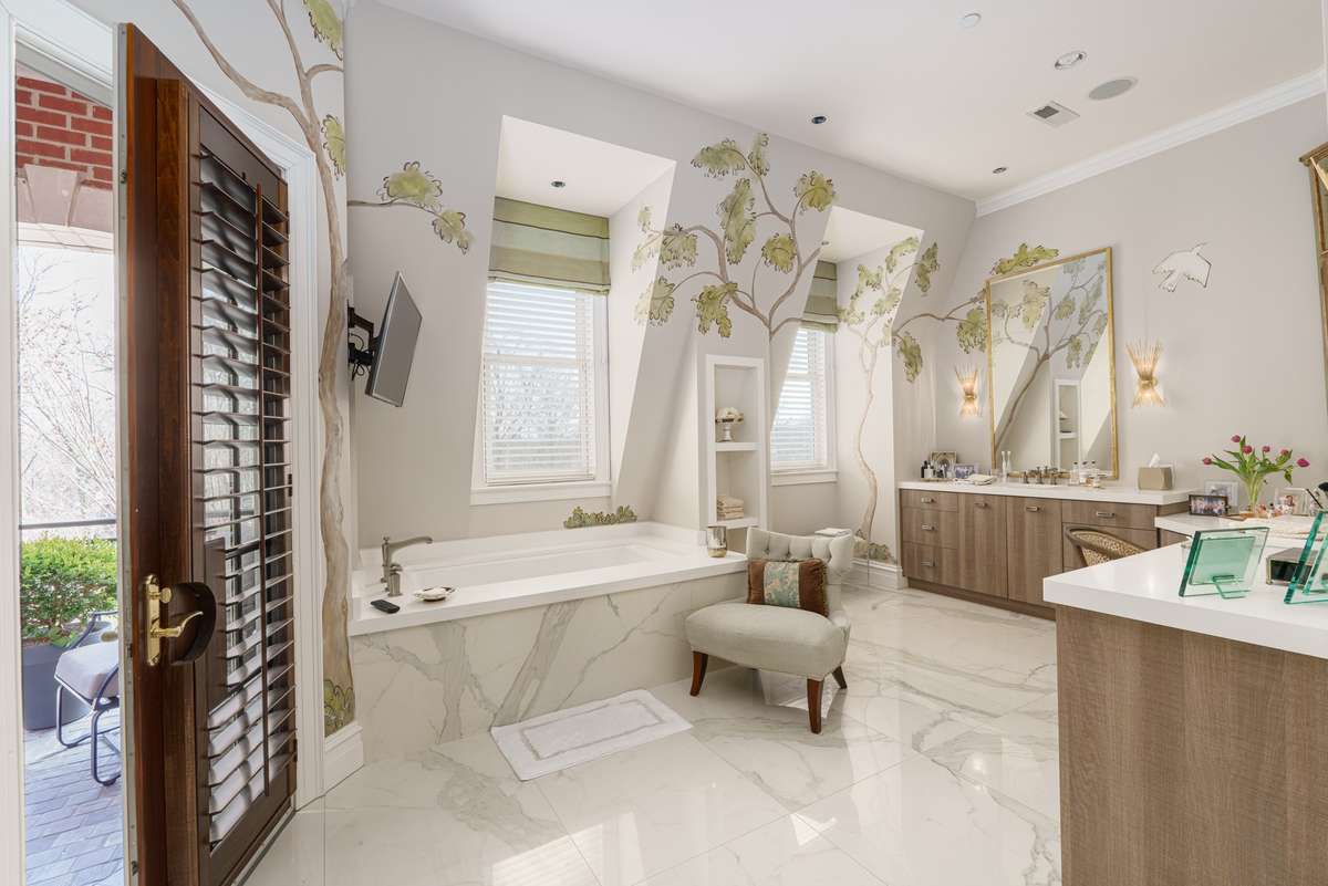 Primary bath features marble floors, two separate vanities, marble shower hand painted murals and private balcony