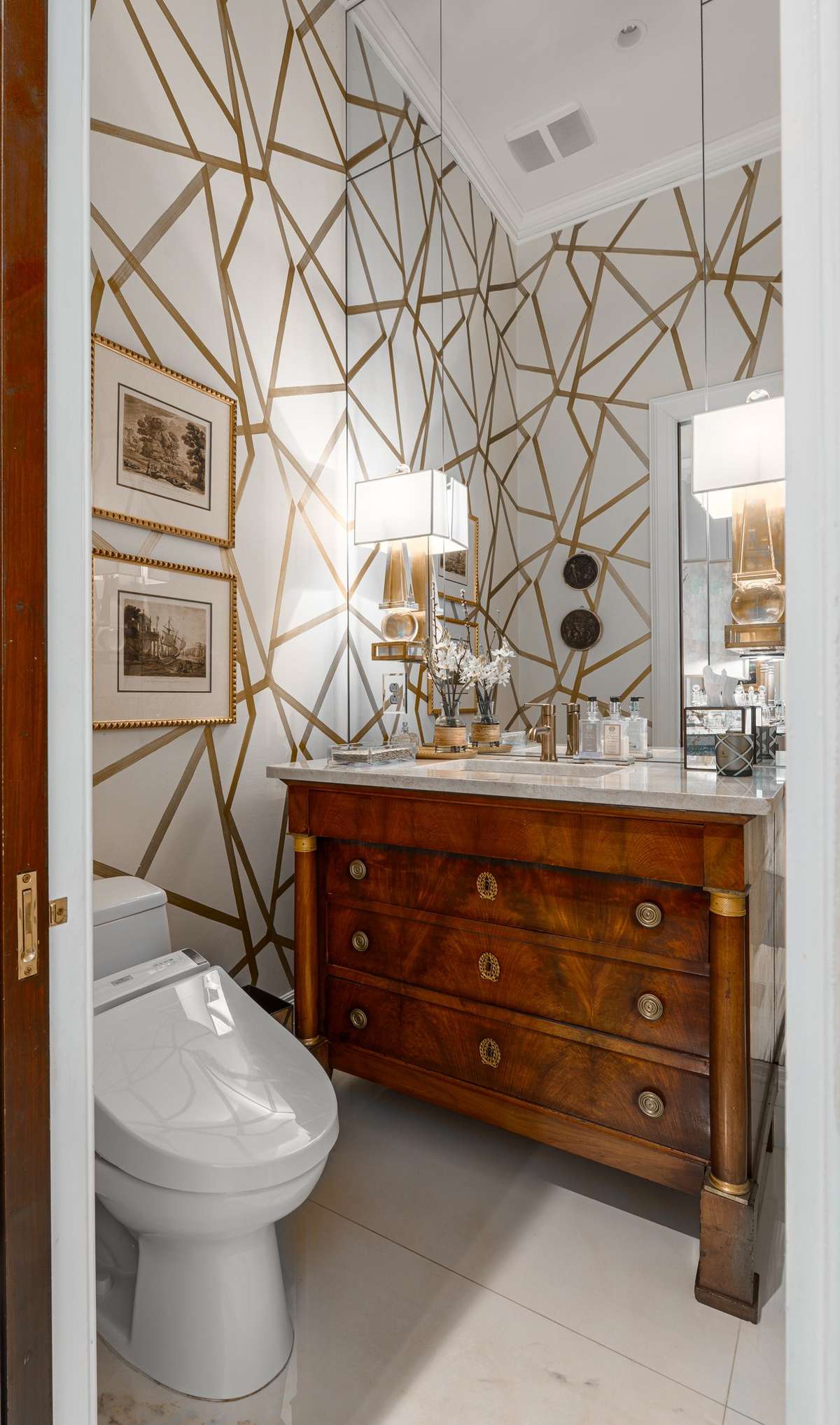Regency vanity and designer sconces showcase this beautiful powder room