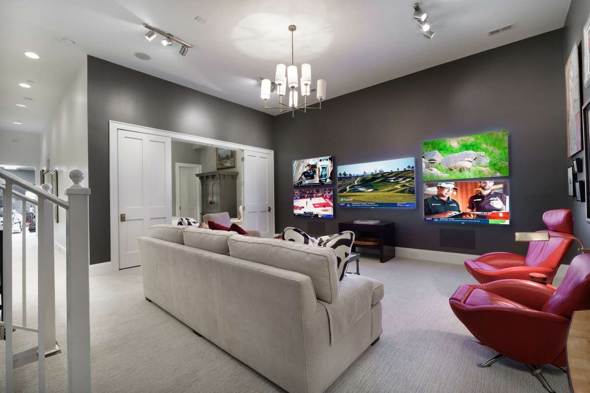 What a dream - media room with 5 TV's, custom wet bar and opens to lower bedroom.