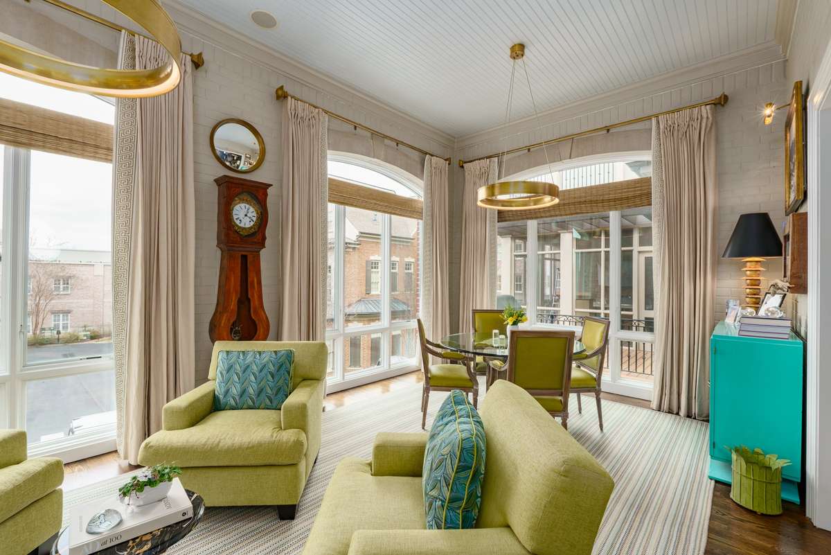 Natural light floods this beautiful sunroom- note designer light fixtures