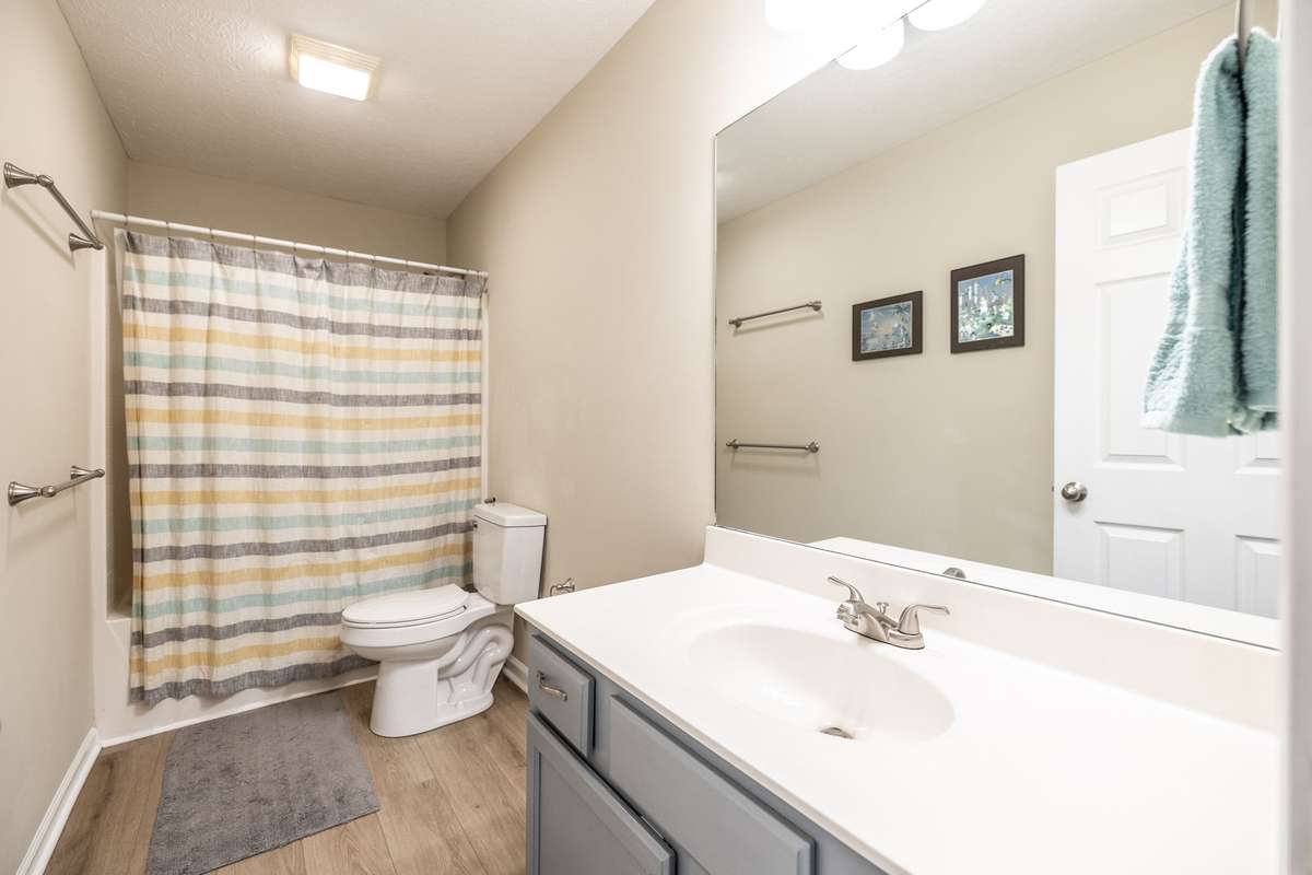 Upstairs hall bath with a tub/shower combo, new cabinet hardware and a new faucet!