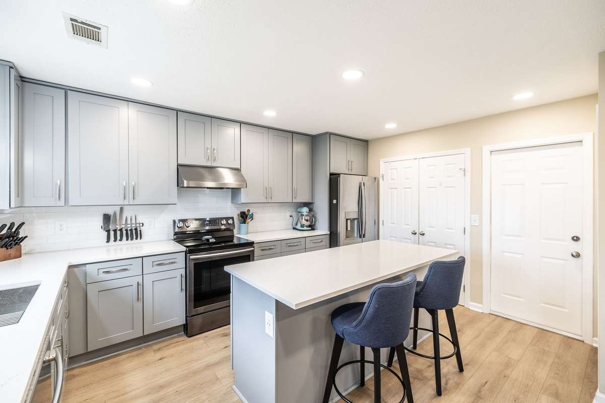 All new cabinetry, quartz countertops, new island with built in convection microwave, tile backsplash, new vented range hood, recessed lighting, new sink with touchless faucet and a coffee bar!