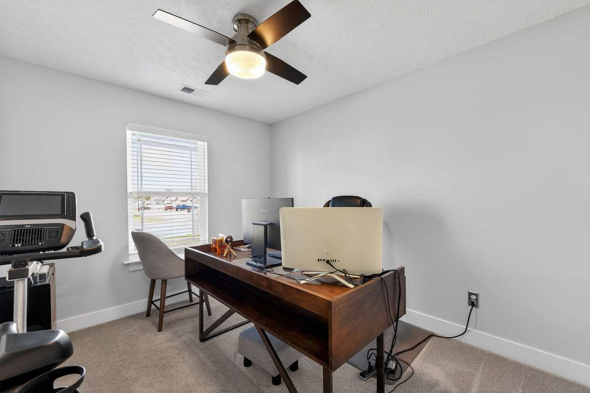 The natural light from the corner window keeps this home office or 3rd bedroom feeling open while you work through the day.