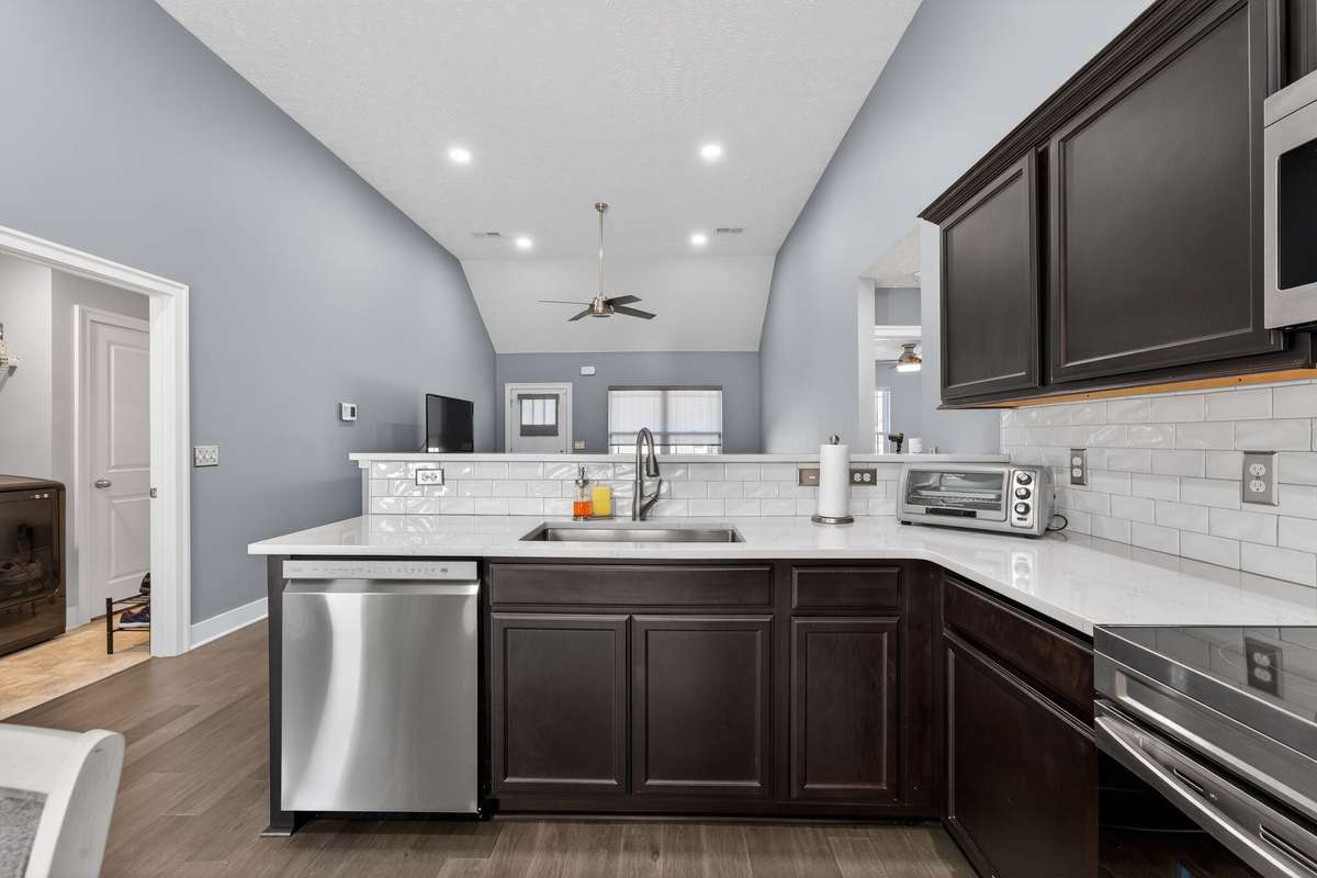 The L-shaped layout keeps the work triangle tight while leaving enough counter space to prep dinner without feeling cramped.