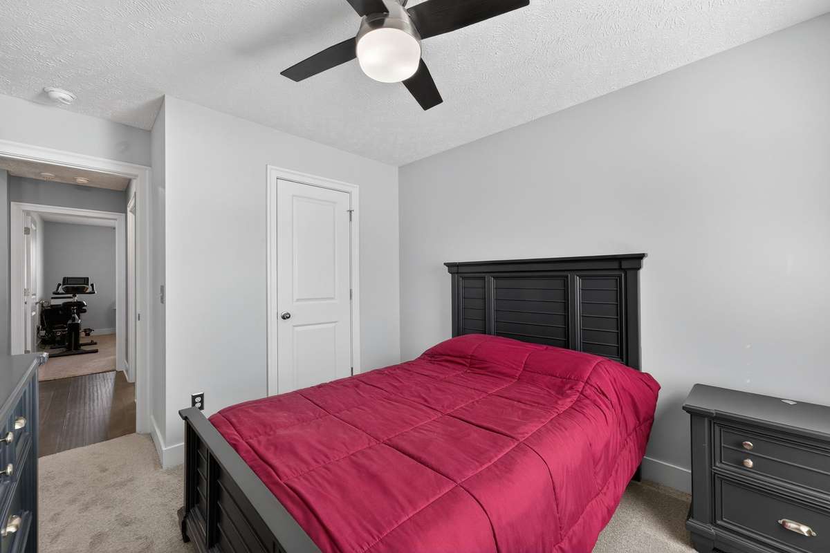 Secondary bedroom fits a full bed with room for a nightstand and dresser without feeling tight